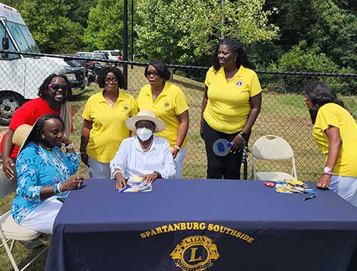 Lions volunteer to serve at the Back-to-school bash held at CC Woodson Community Center in August 2022.