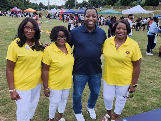 cLions Earlene, Kathy and Linda share a special moment with TV7 and news anchor Melicah Rogers at the back-to-school bash. 